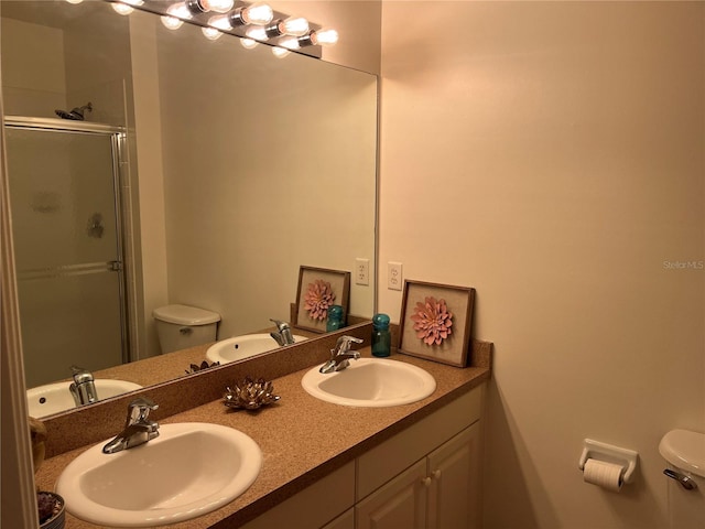 bathroom with a shower with door, vanity, and toilet