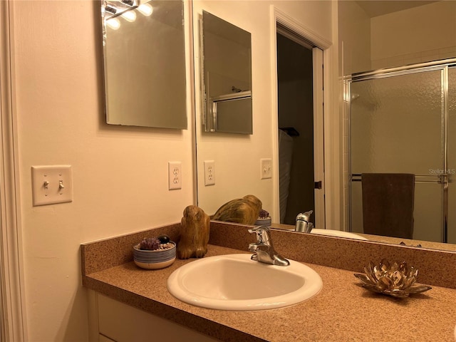 bathroom with walk in shower and vanity