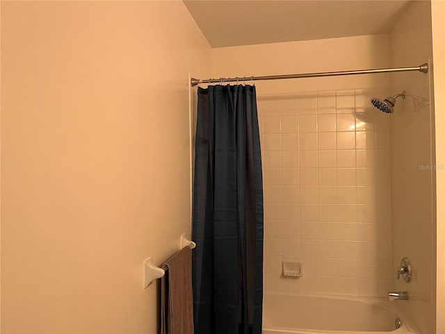 bathroom with shower / bath combination with curtain