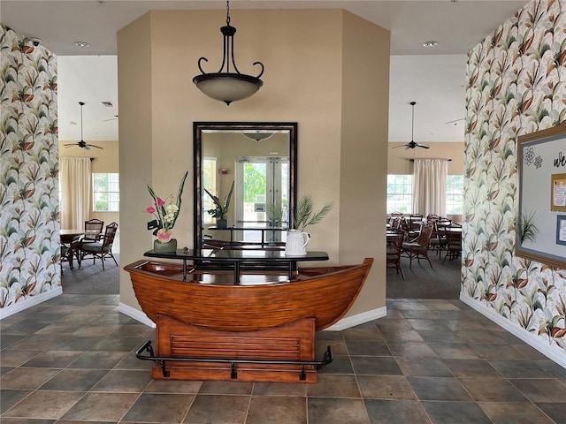 interior space featuring a high ceiling and ceiling fan