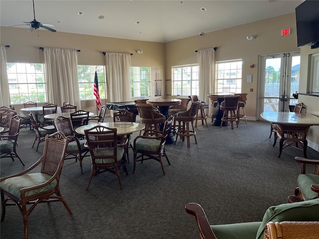 carpeted dining area with ceiling fan and plenty of natural light