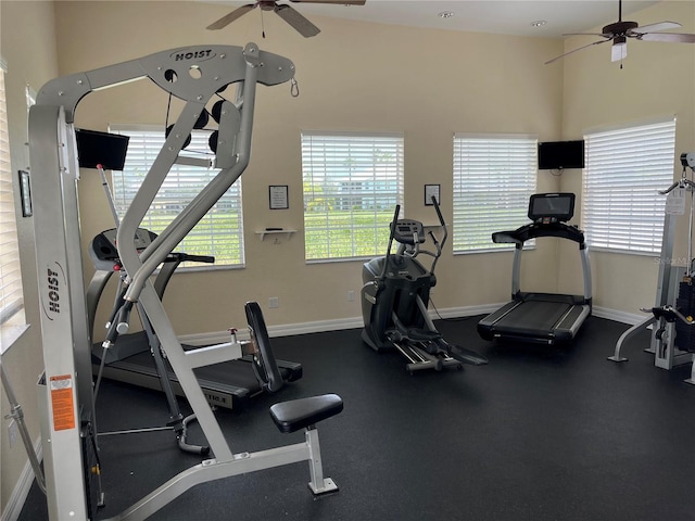 exercise room featuring ceiling fan and high vaulted ceiling