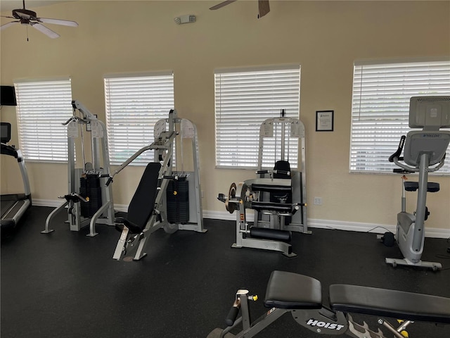 gym with ceiling fan and a healthy amount of sunlight