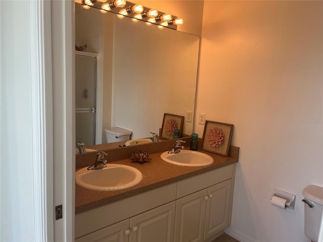 bathroom featuring walk in shower, vanity, and toilet