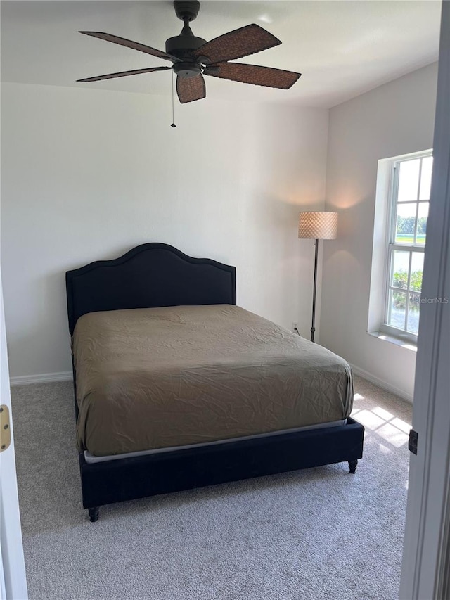 bedroom with ceiling fan and carpet floors