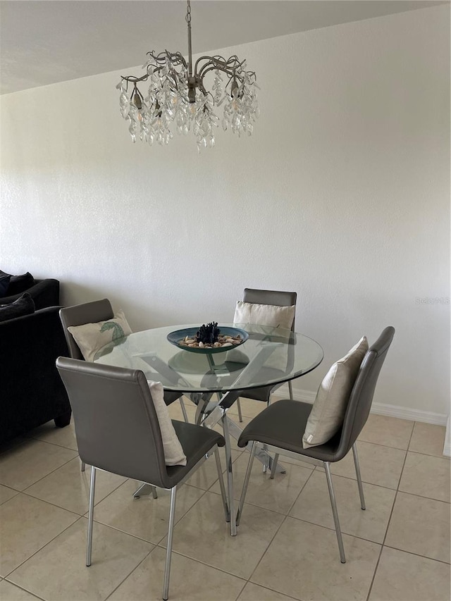 dining area with light tile patterned flooring and a notable chandelier