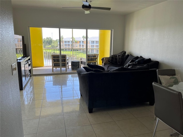 tiled living room featuring ceiling fan