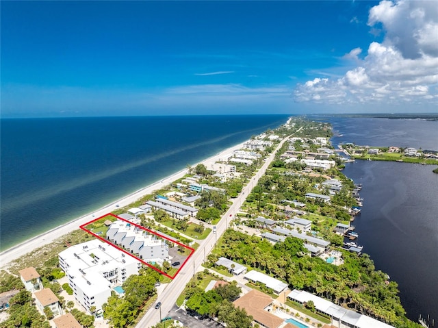 birds eye view of property featuring a water view and a beach view