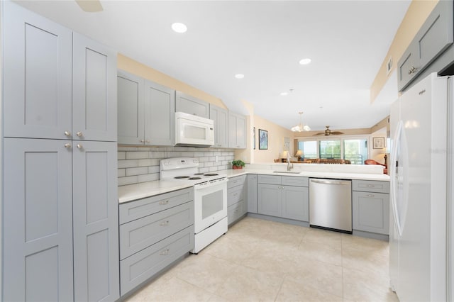 kitchen featuring ceiling fan, gray cabinetry, white appliances, and tasteful backsplash