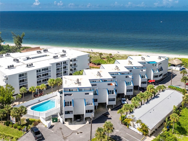 drone / aerial view featuring a beach view and a water view