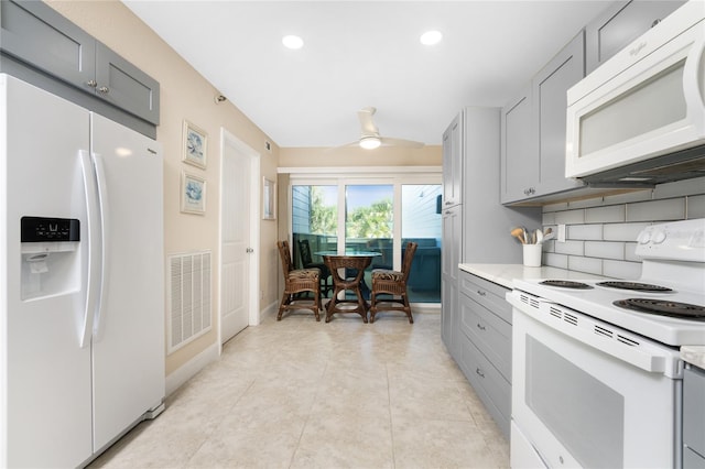 kitchen with backsplash, light tile patterned floors, gray cabinetry, white appliances, and ceiling fan