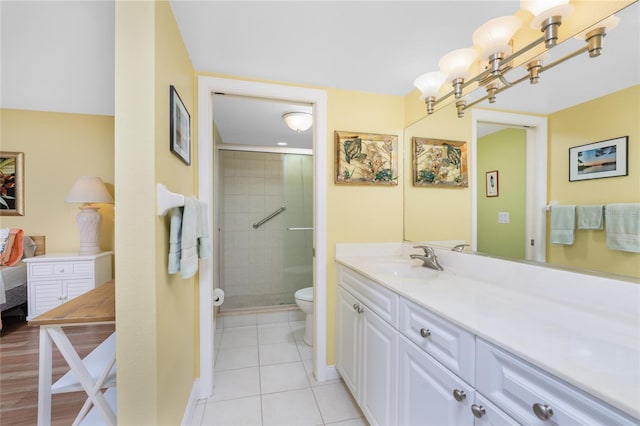 bathroom with an enclosed shower, tile patterned floors, toilet, and vanity