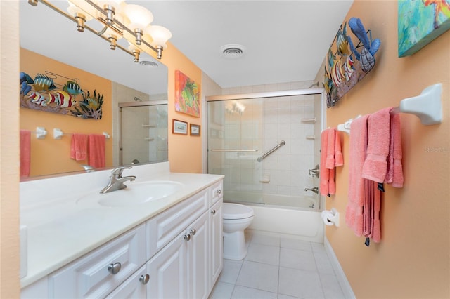 full bathroom featuring tile patterned flooring, toilet, enclosed tub / shower combo, and vanity