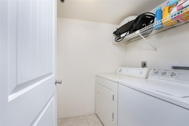 laundry area with independent washer and dryer and light tile patterned flooring