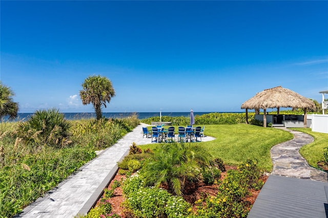 exterior space with a water view, a lawn, and a gazebo