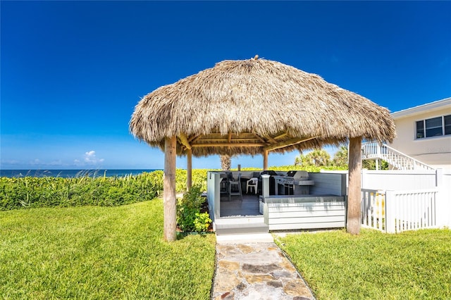 view of property's community with a water view, a yard, and a gazebo