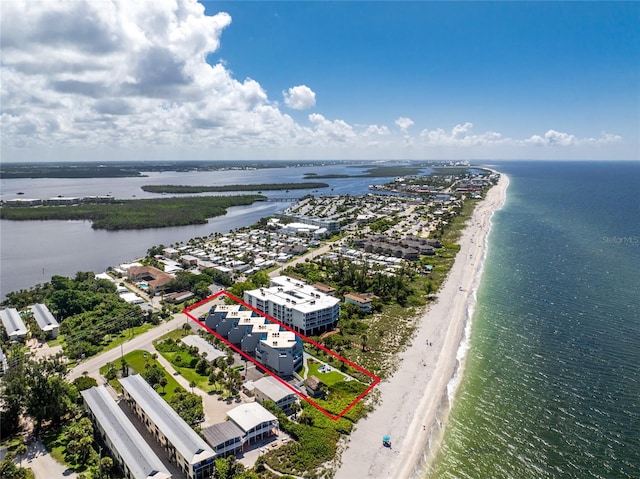 bird's eye view featuring a water view and a beach view