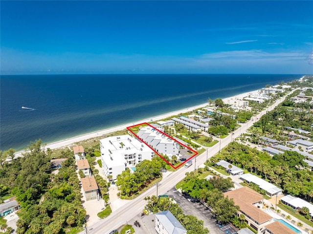 drone / aerial view featuring a water view and a beach view