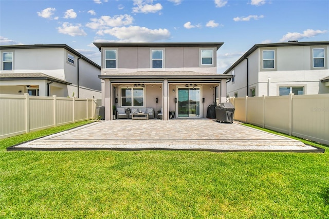 back of house featuring a fenced backyard, a patio area, and a yard