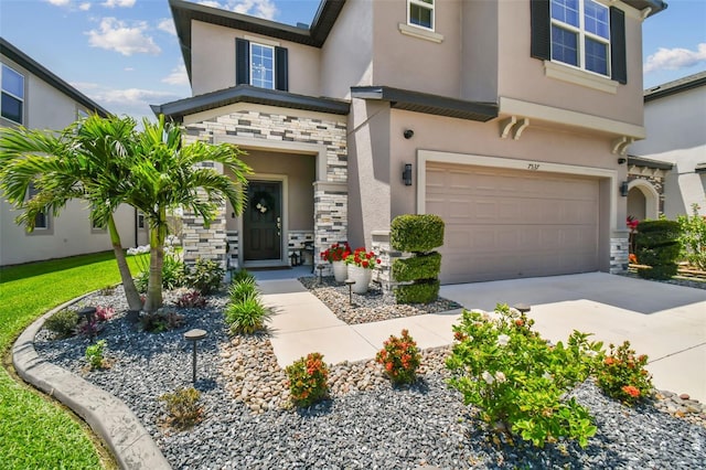 view of front of property with concrete driveway, a garage, stone siding, and stucco siding