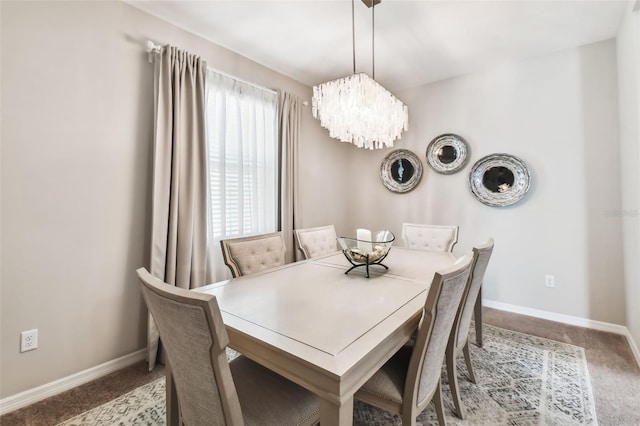 dining area featuring baseboards and carpet