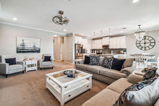 living area featuring visible vents, an inviting chandelier, recessed lighting, crown molding, and light colored carpet