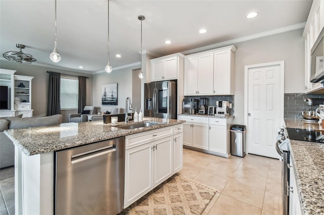 kitchen featuring open floor plan, white cabinets, appliances with stainless steel finishes, and ornamental molding