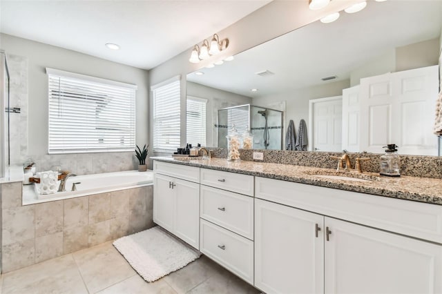 full bathroom with double vanity, a stall shower, a sink, tile patterned floors, and a bath