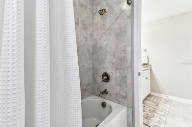 bathroom with shower / bath combo with shower curtain and baseboards