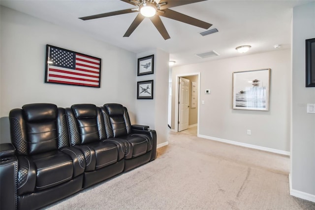 cinema room with ceiling fan, carpet, visible vents, and baseboards