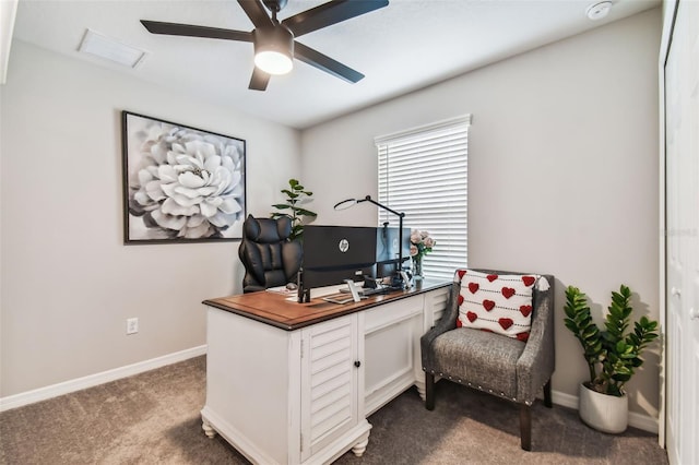 office featuring dark colored carpet, visible vents, baseboards, and ceiling fan