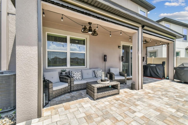 view of patio / terrace with an outdoor living space, area for grilling, and central AC