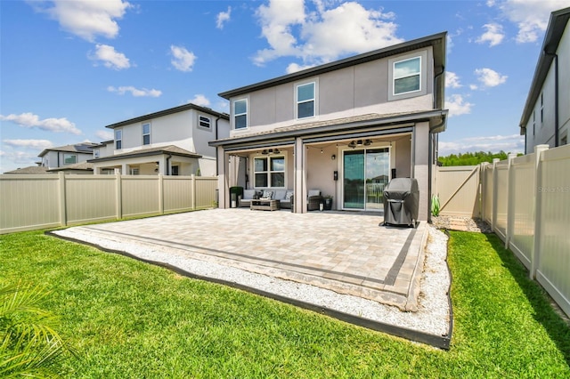 back of property featuring stucco siding, a yard, a fenced backyard, and a patio area