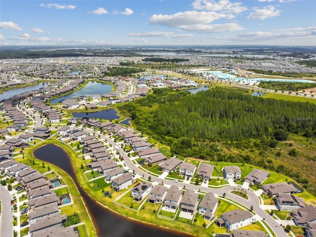 drone / aerial view featuring a residential view and a water view