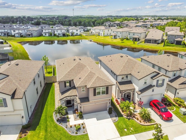 bird's eye view with a residential view and a water view