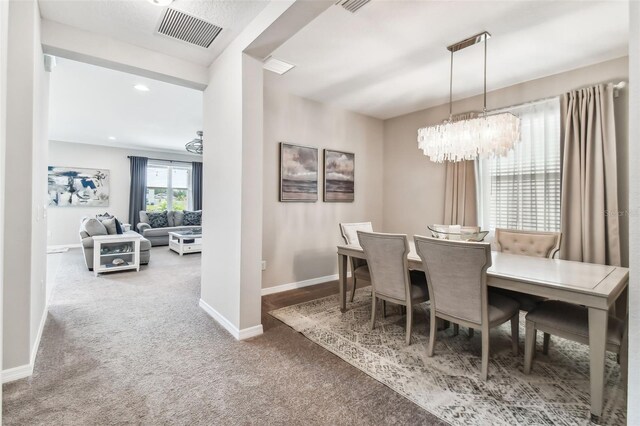 7537 Pool Compass Loop, Wesley Chapel, FL 33545 - carpeted dining room with a chandelier, baseboards, and recessed lighting