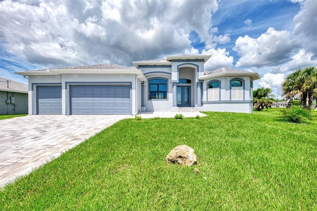 view of front of home featuring a front yard and a garage