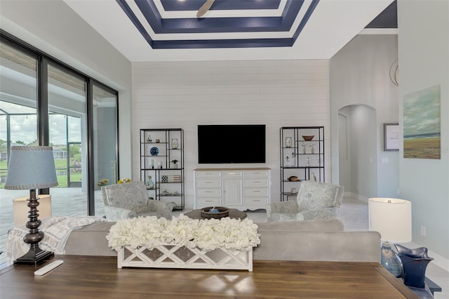 living room with wood-type flooring and a raised ceiling