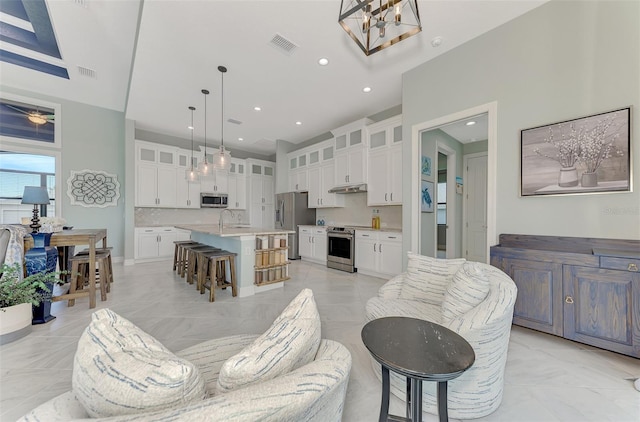 living room featuring a chandelier and sink