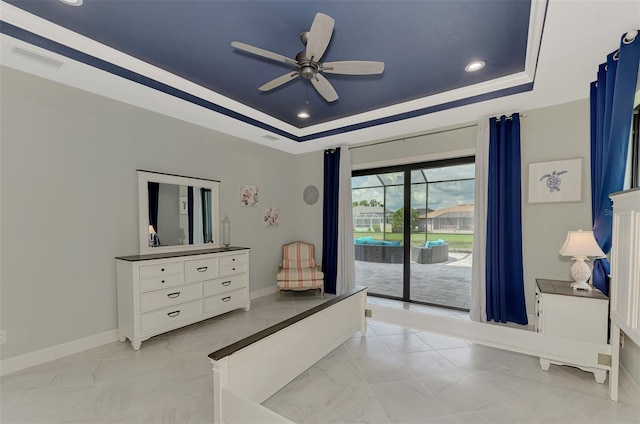 bedroom featuring a raised ceiling, access to outside, and ceiling fan