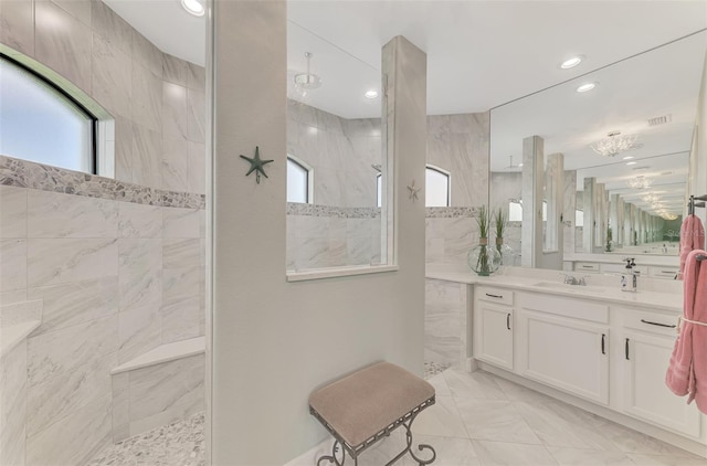 bathroom with plenty of natural light, vanity, and tiled shower