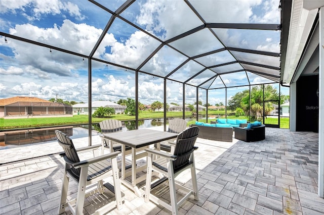 view of patio with a lanai, an outdoor hangout area, and a water view