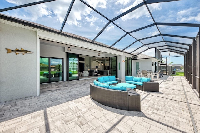 view of patio / terrace featuring an outdoor living space and glass enclosure