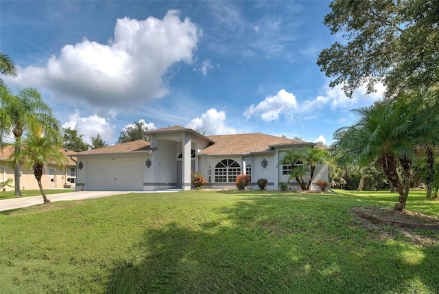 mediterranean / spanish home with a front lawn and a garage