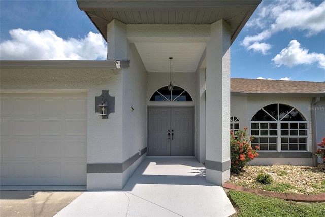 view of exterior entry with a garage