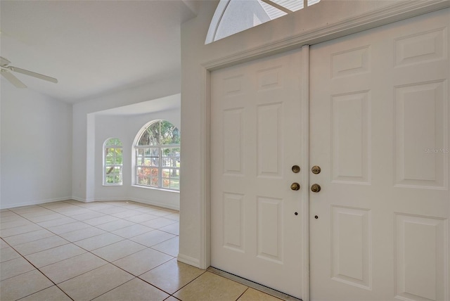 foyer featuring light tile patterned flooring and ceiling fan