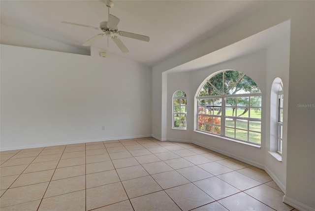 tiled empty room with lofted ceiling and ceiling fan