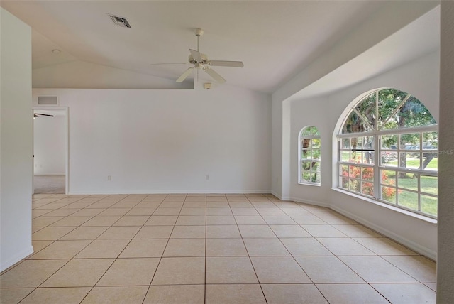 tiled empty room featuring ceiling fan and vaulted ceiling