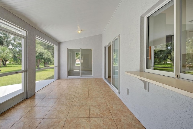 unfurnished sunroom with lofted ceiling