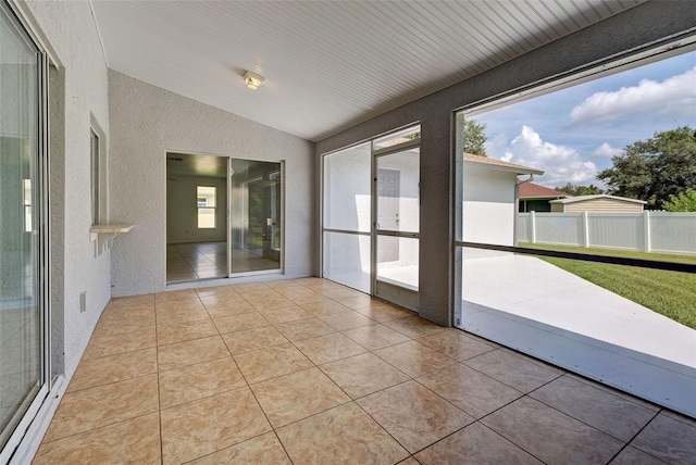 unfurnished sunroom with vaulted ceiling and wooden ceiling